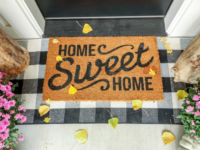 Orange and black Door matt that says Home Sweet Home